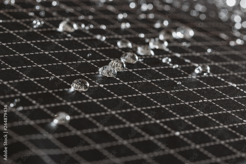 Obraz premium Rain Water droplets on a black waterproof fabric of the umbrella