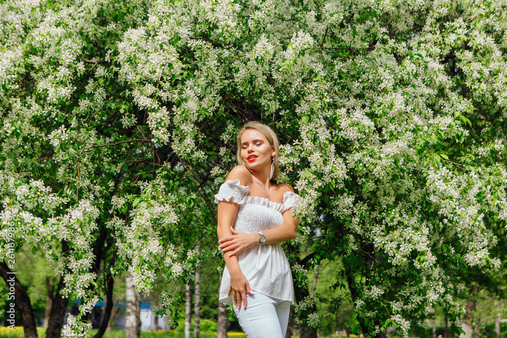 Sexy modern bride enjoing blooming apple tree flowers. Sexy modern bride enjoing blooming apple tree flowers.