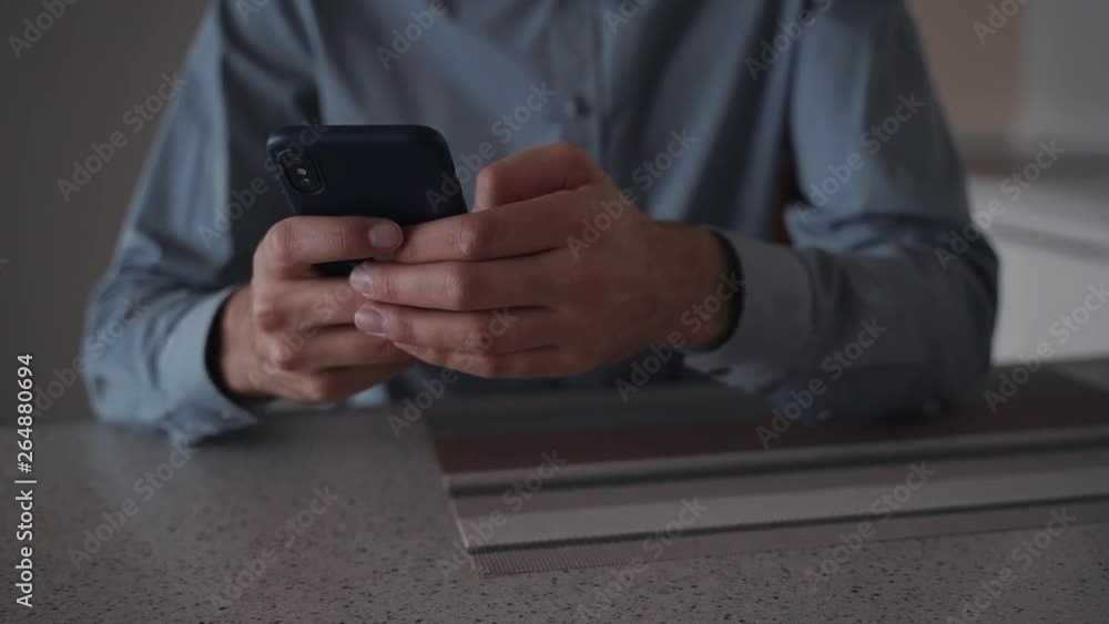 Man using smartphone and sitting at home Man using smartphone and sitting at home