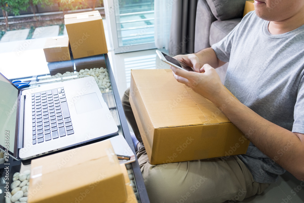 Startup small business SME, entrepreneur owner using smartphone or note book taking receive and checking online purchase shopping order to preparing pack product box. Startup small business SME, entrepreneur owner using smartphone or note book taking receive and checking online purchase shopping order to preparing pack product box.