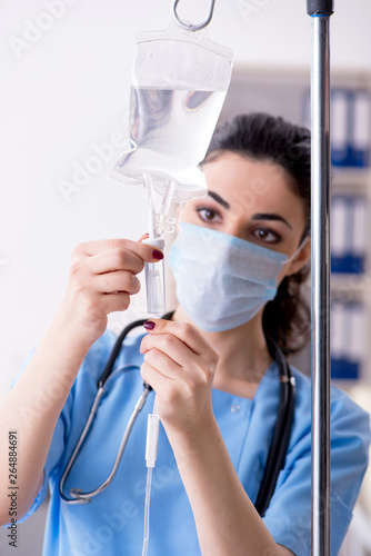 Fotografie Young female doctor in infusion concept