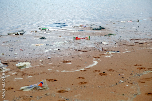 Dirty beach in the morning, garbage pollution
