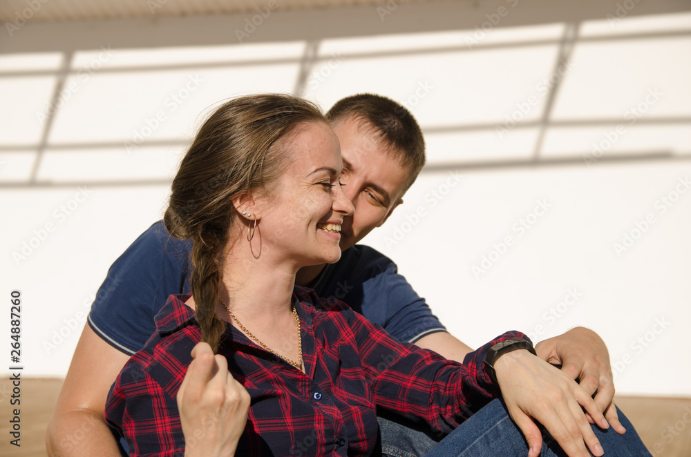 Fototapeta premium the guy with the short haircut and the girls with braid and plaid shirt look at each other