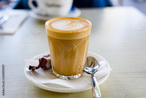 Glass of chai latte on a table, close up.
