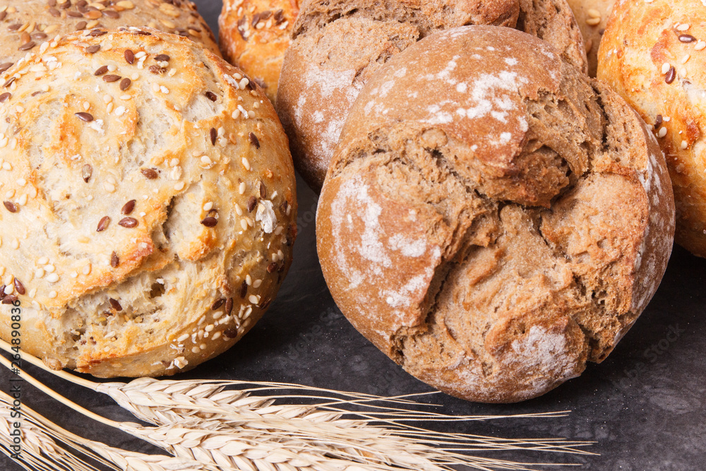 Wholegrain rolls or bread with seeds and ears of rye grain Wholegrain rolls or bread with seeds and ears of rye grain