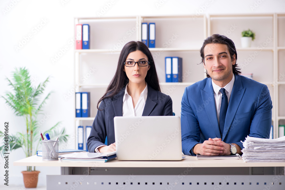 Two employees working in the office Two employees working in the office