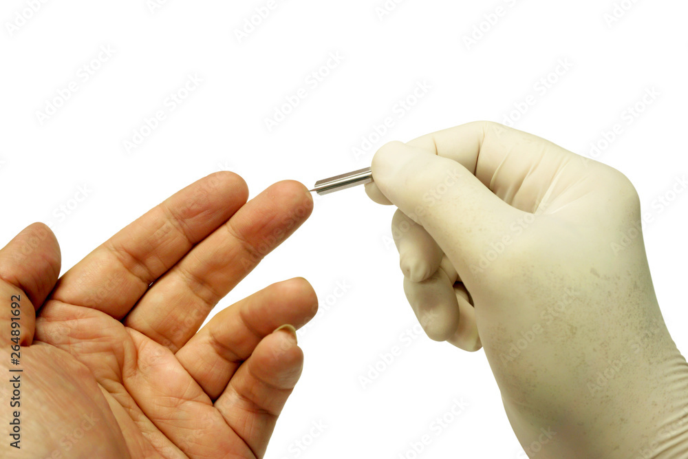 Hand of doctor in white medical glove holding blood lancet stab on human middle finger to check glucose in the blood isolate on white background and make with paths. Hand of doctor in white medical glove holding blood lancet stab on human middle finger to check glucose in the blood isolate on white background and make with paths.