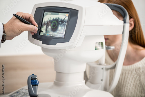 young girl patient on reception at doctor ophthalmologist. diagnostic ophthalmologic equipment. medicine concept photo