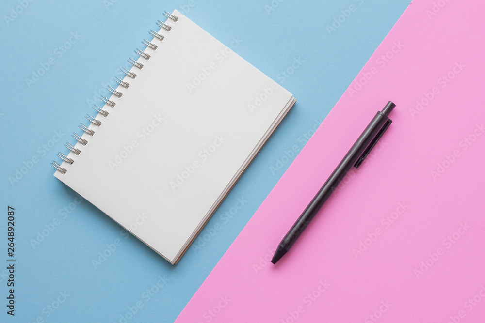 notebook and pen on pink and blue background notebook and pen on pink and blue background