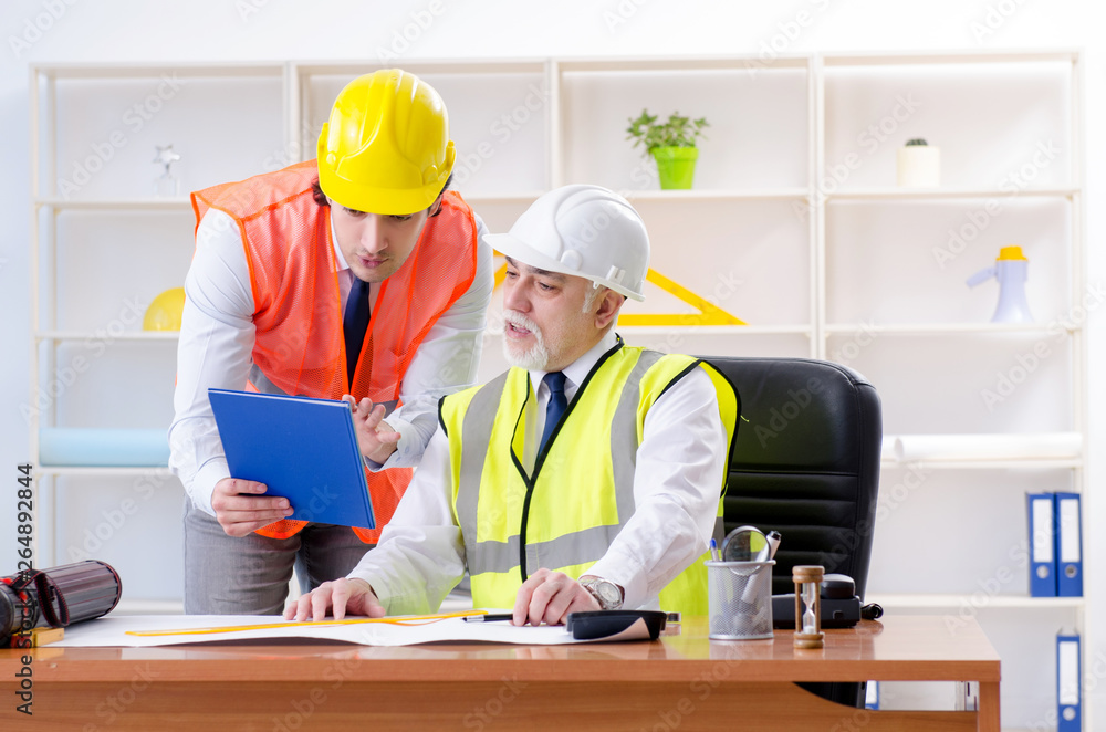 Two engineers colleagues working under project Two engineers colleagues working under project