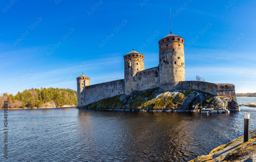 Beautiful view of Olavinlinna, Olofsborg ancient fortress, the 15th-century medieval three - tower castle located in Savonlinna city on a sunny May day. lake Saimaa, Finland. Beautiful view of Olavinlinna, Olofsborg ancient fortress, the 15th-century medieval three - tower castle located in Savonlinna city on a sunny May day. lake Saimaa, Finland.