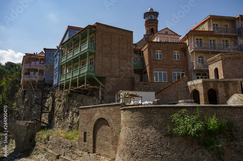 Traditional georgian architecture with wooden balconies in Abanotubani historical part of Tbilisi near waterfall in botanical garden.Georgia, unesco heritage