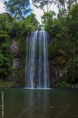 people standing under the milla milla falls and taking a shower  Queensland  Australia