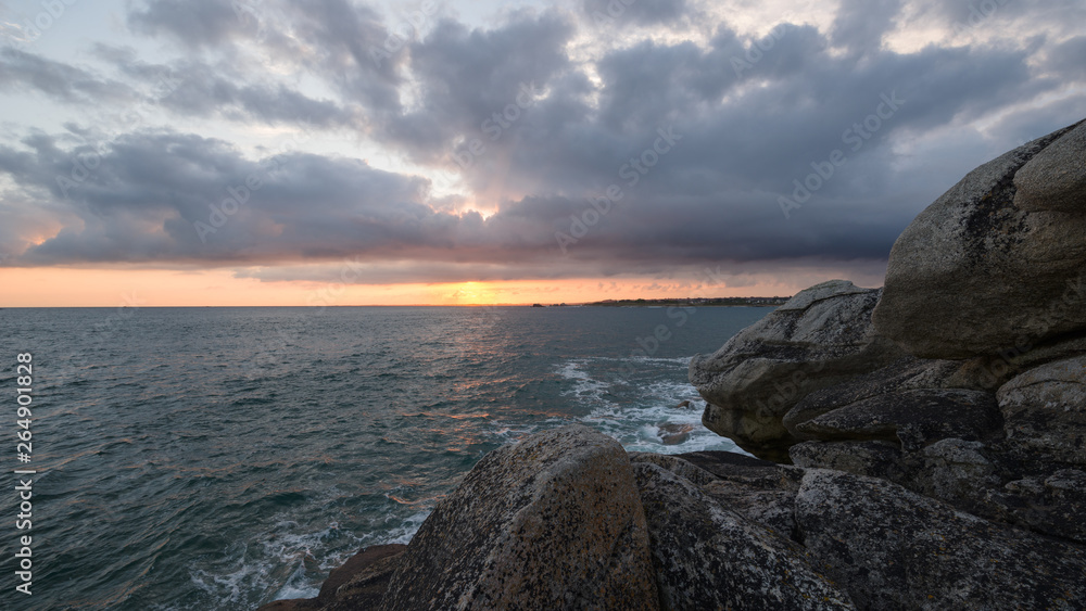 Panoramic view of sunrise over the rocky Breton coast against cloudy sky, France, Brittany, Finistere