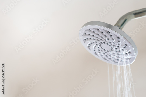 Leaking water from a shower head. Concept of water wastage