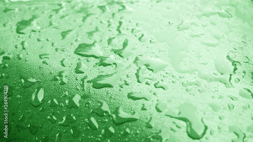 Water droplets texture on green background