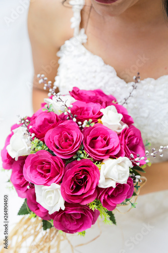 bride holding a purple and white wedding bouquet of flowers. Bride with wedding bouquet 