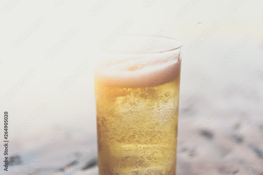 Fresh beer water in to glass with ice and froth Fresh beer water in to glass with ice and froth
