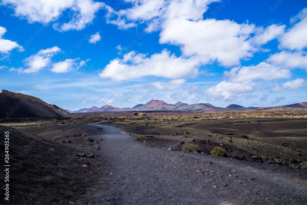 Spain, Lanzarote, Popular hiking trail alongside majestic volcanic mount el cuervo in dry caldera lava fields