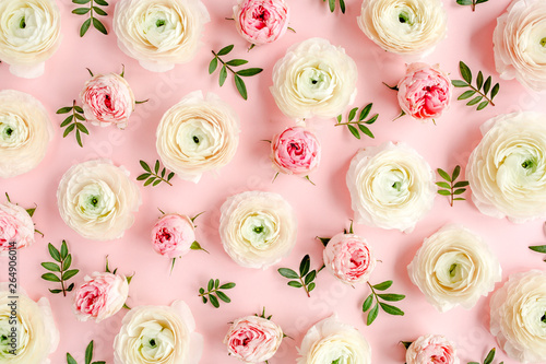 Floral background texture made of pink ranunculus and roses flower buds on pink background.  Flat lay, top view floral background.