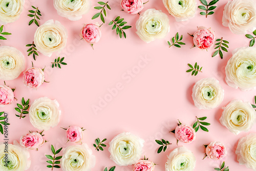 Fotografie, Obraz Floral background frame made of pink ranunculus and roses flower buds on pink background