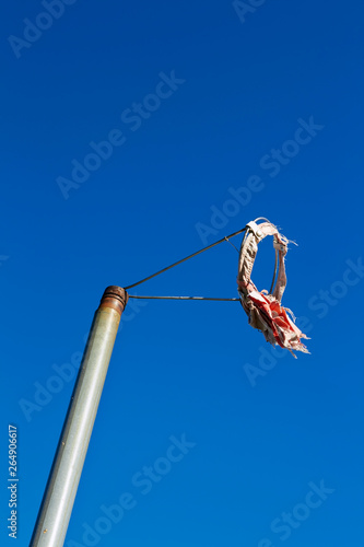 worn out windsock against blue sky