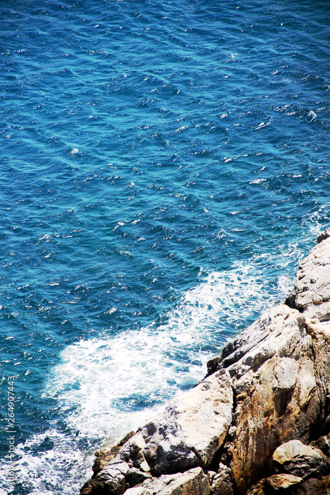 Fototapeta premium island of Greece. The island of Ikaria in the Aegean sea. Turquoise, blue sea. Rocky shore. Tourism and travel around the world.