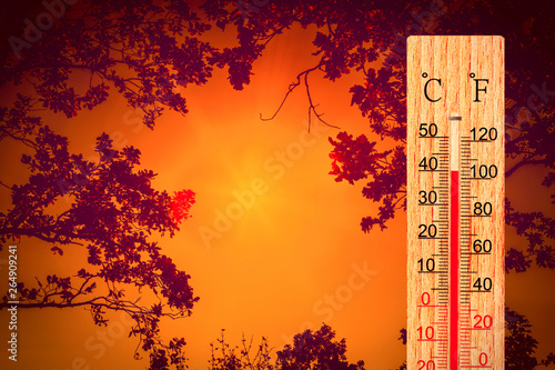 Summer heat. Thermometer display plus 40 degrees celsius. Orange sun in red sky