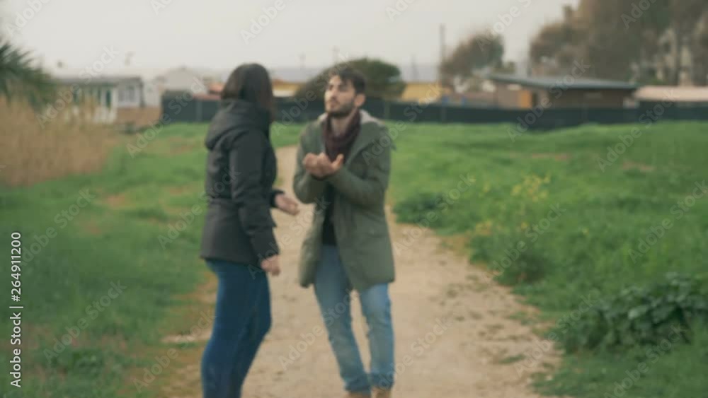 Young couple arguing on park path.anger, misunderstanding, frustration Young couple arguing on park path.anger, misunderstanding, frustration