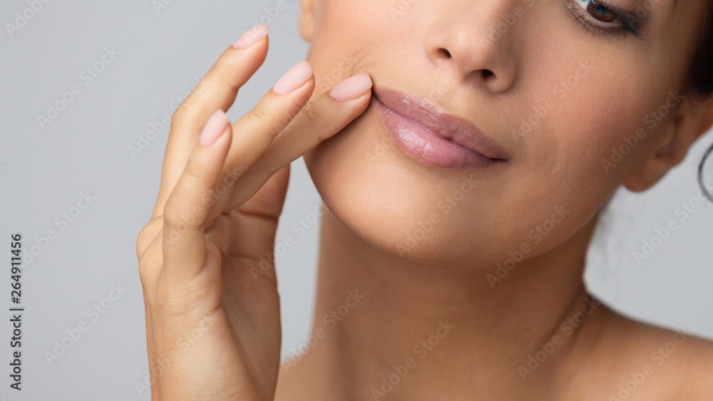 Cosmetology concept. Girl holding hand near lips Cosmetology concept. Girl holding hand near lips