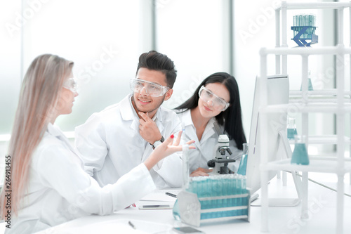 team of scientists discussing something at the Desk