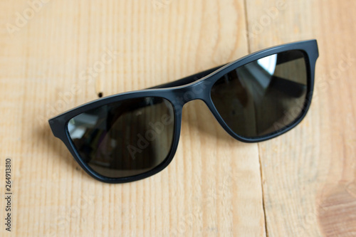 black eyeglasses on a wooden background