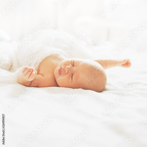 cute newborn baby is sleeping in the nursery.