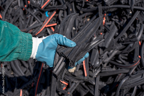 Close up of man holding pieces of waste shredded rubber