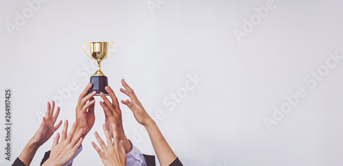 Obraz na płótnie Hands scramble for the golden trophy cup, concept business