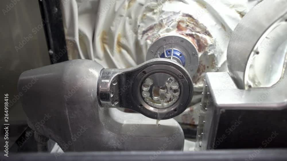 Closeup view at carving process in dental milling machine Closeup view at carving process in dental milling machine