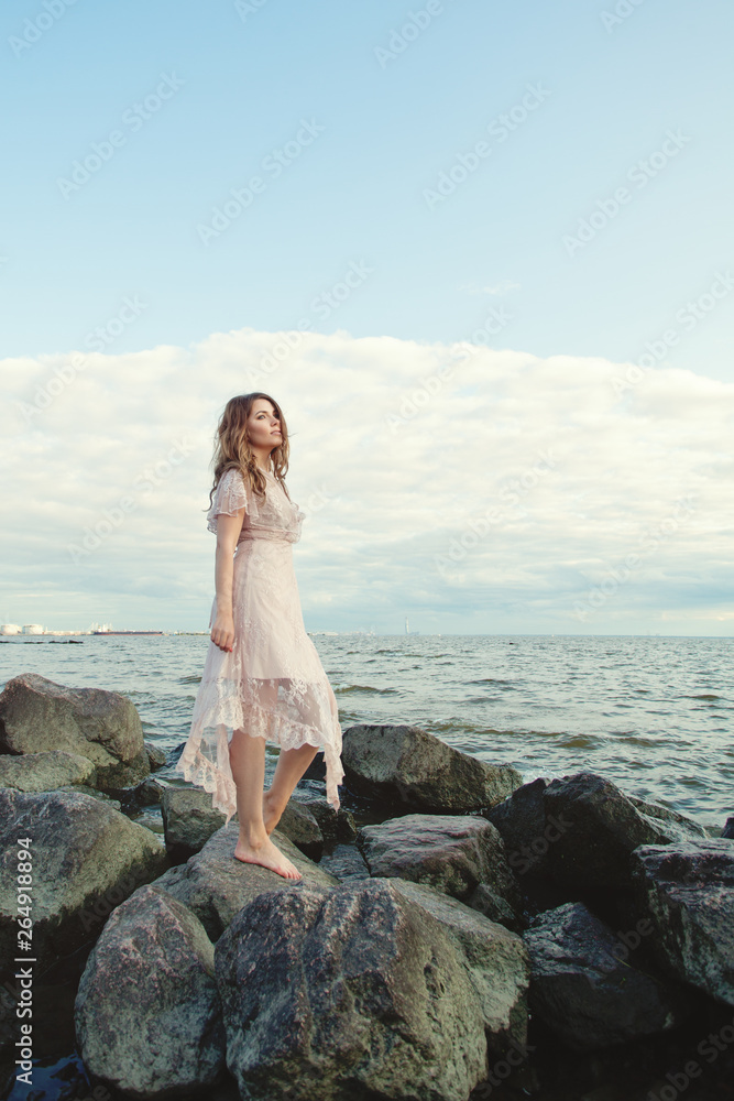 Cute woman on ocean coast, portrait