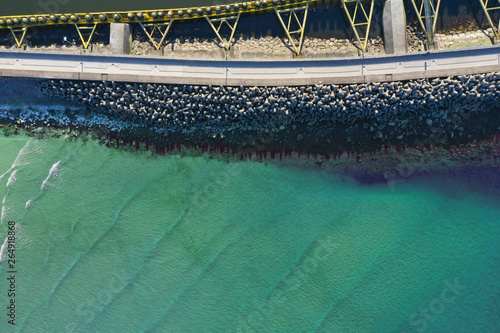 Aerial top down view on sea breakwaters and ship port entrance.