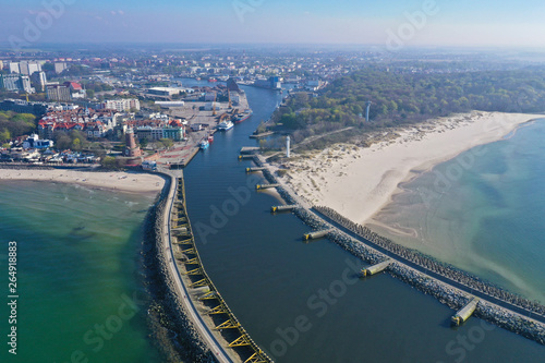 Aerial view on Kolobrzeg cityscape with lighthouse, ship port, port entrance and breakwaters