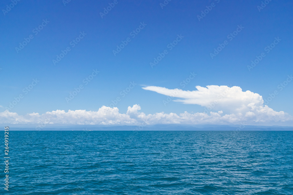 Clear sky with enormous cloud over the sea at Koh Mak in Trat, Thailand. Perfect background for ocean travel, sea business with copy space. Clear sky with enormous cloud over the sea at Koh Mak in Trat, Thailand. Perfect background for ocean travel, sea business with copy space.