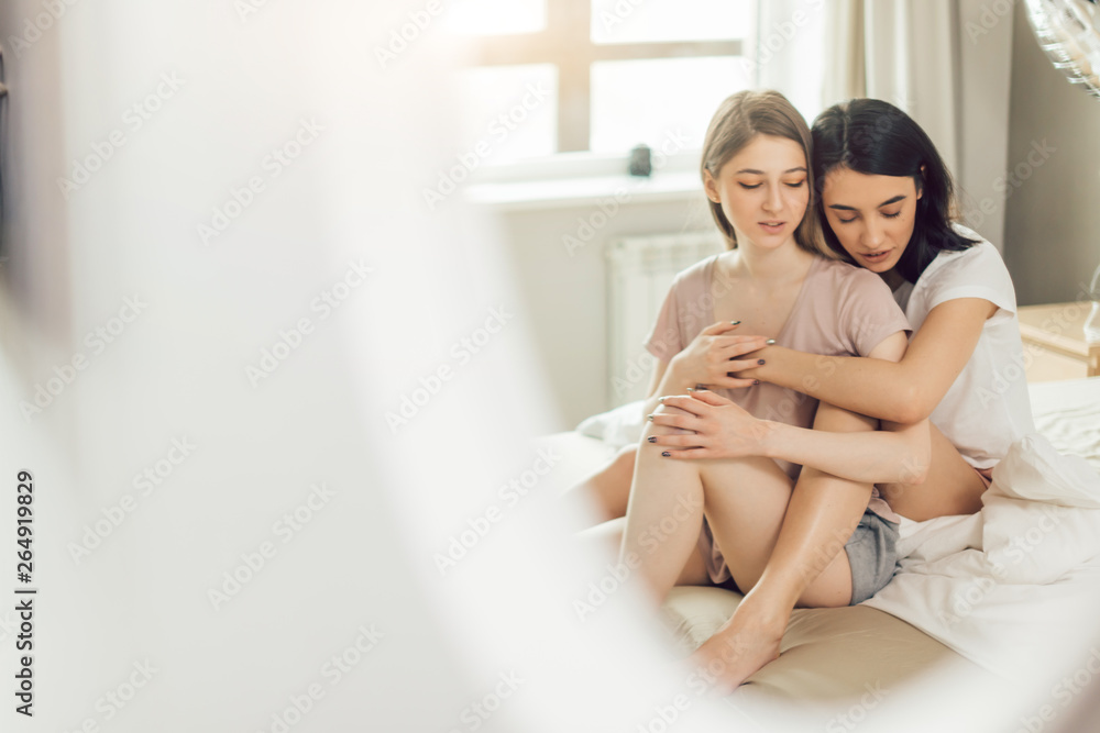 attractive hipsters embracing each other. close up photo. copy space. white curtain in the foreground of the photo. relationship concept attractive hipsters embracing each other. close up photo. copy space. white curtain in the foreground of the photo. relationship concept