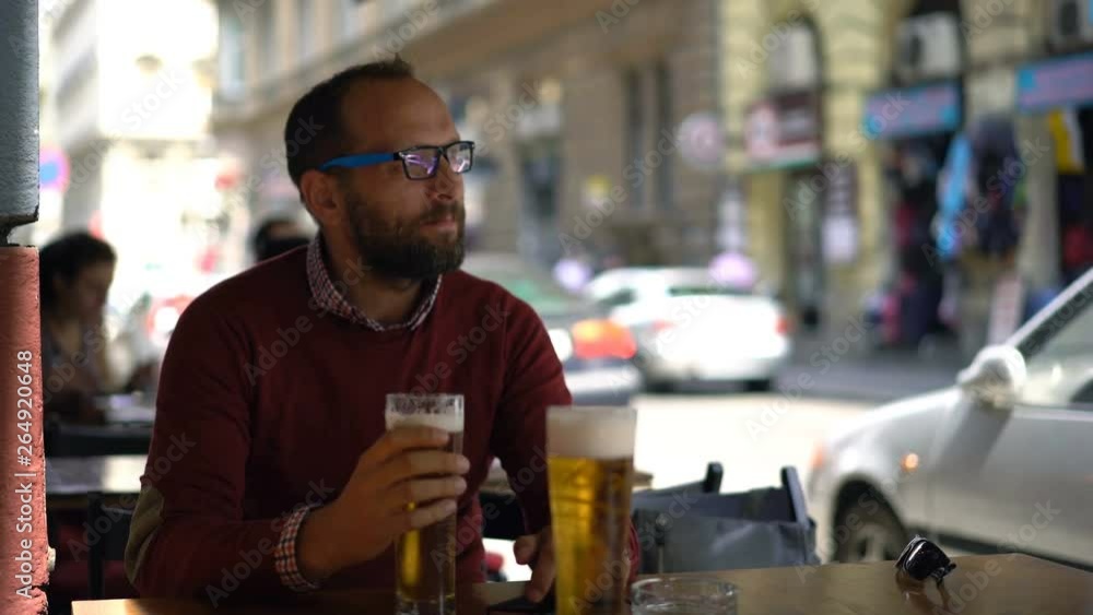 Young man drinking beer in cafe Young man drinking beer in cafe