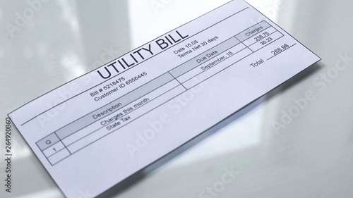 Utility bill lying on table, payment for services, month expenses, tariff