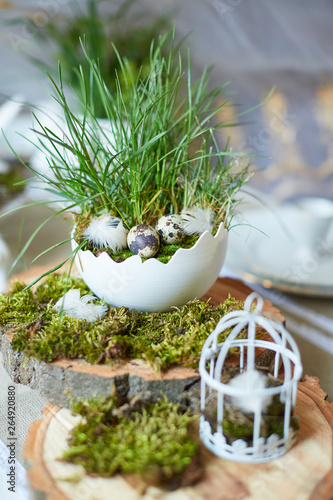 Easter table set. Decorated with eggs, nests and flowers.