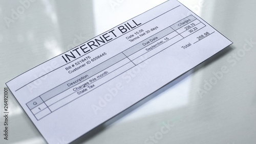 Internet bill lying on table, payment for services, month expenses, tariff photo