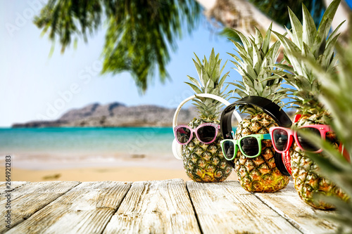 Fresh fruits on pineapple and summer time on beach 