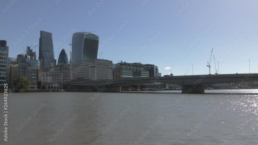 A view of the Thames river with financial buildings in the background. A view of the Thames river with financial buildings in the background.