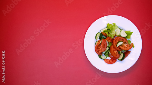 Vegetable salad on white plate bright background, healthy nutrition, vitamins