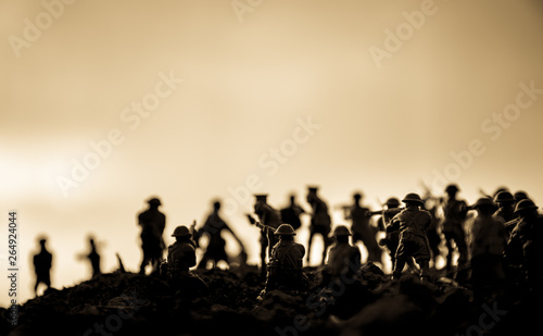 War Concept. Military silhouettes fighting scene on war fog sky background, World War Soldiers Silhouettes Below Cloudy Skyline At night. Attack scene. Armored vehicles. Tanks battle. Decoration © zef art