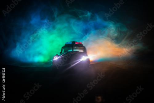 Police cars at night. Police car chasing a car at night with fog background. 911 Emergency response